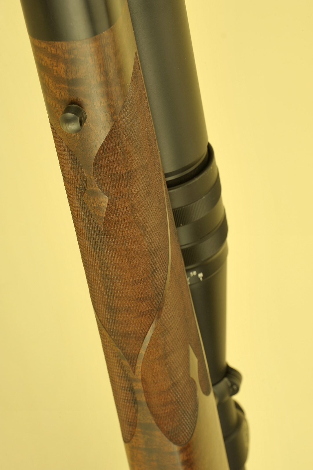 This photo shows how the checkering pattern follows around the forend with a complete three-panel coverage to include a ribbon for that custom look.